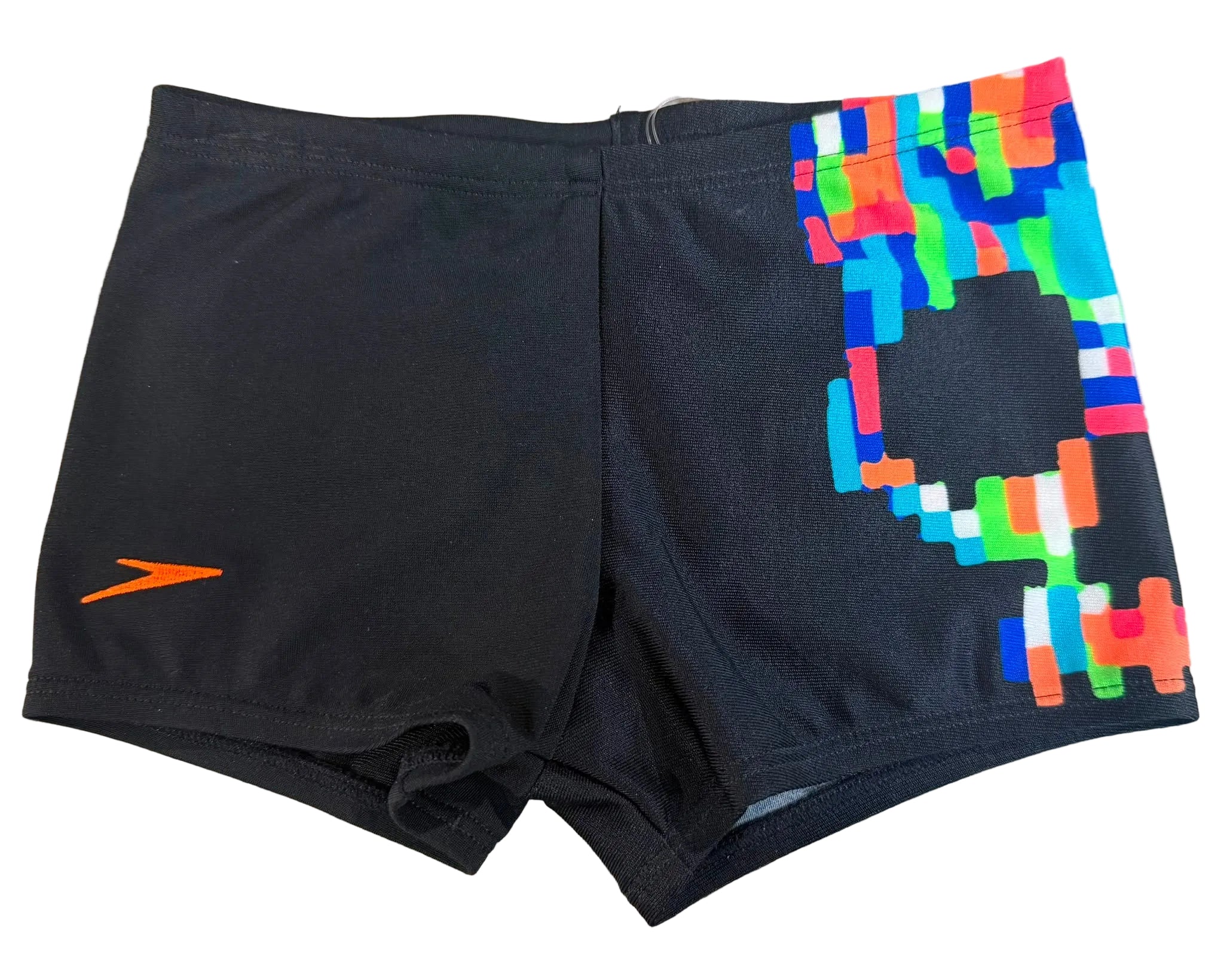 Black athletic swim trunks with a bright multicolor geometric pattern on the right leg and an orange Speedo logo on the left leg, laid flat on a wood-grain surface.